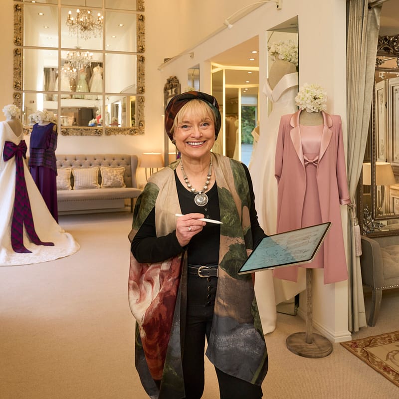 designer in studio holding i pad showing sketch