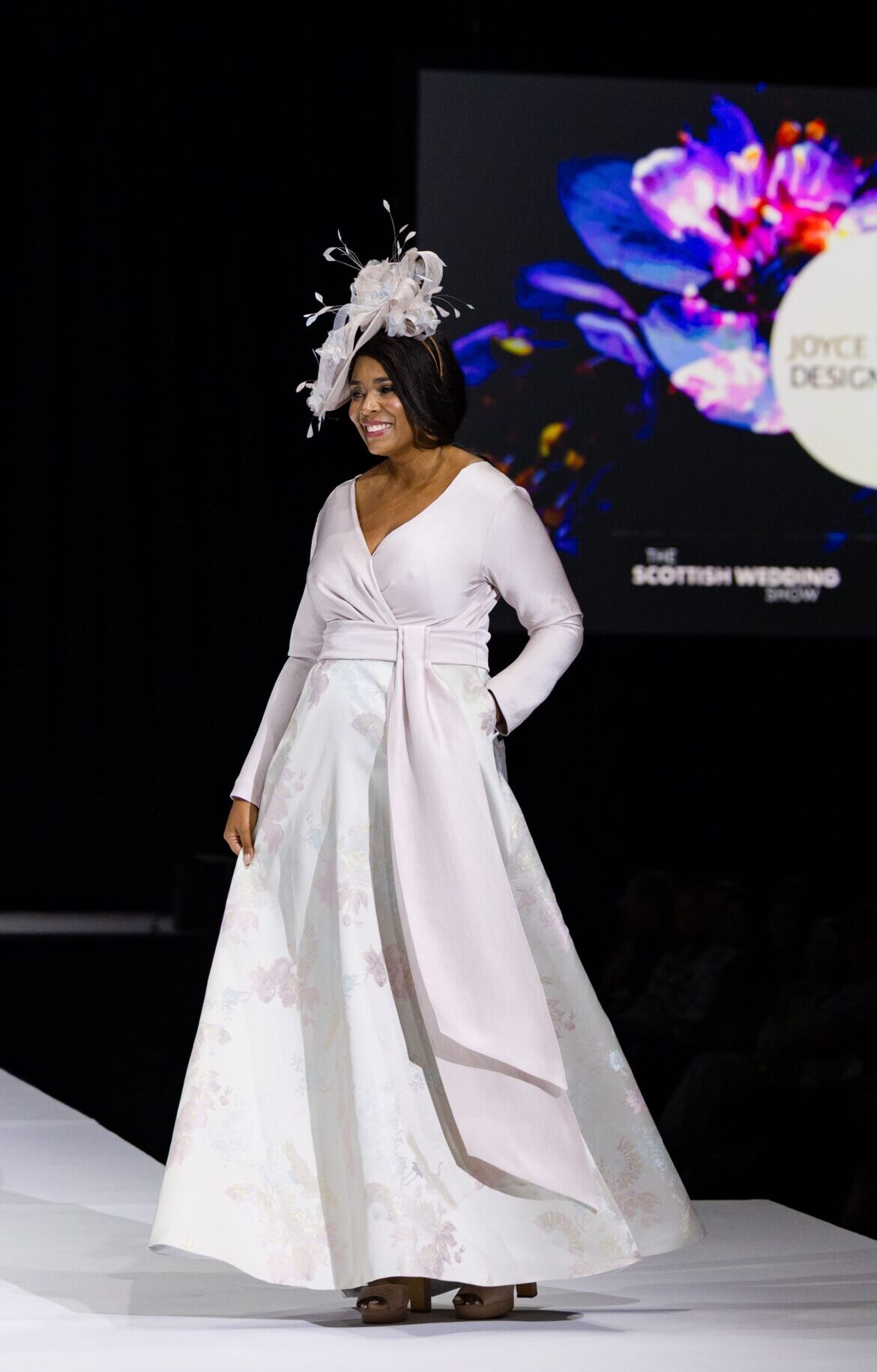Model on catwalk with long dress
